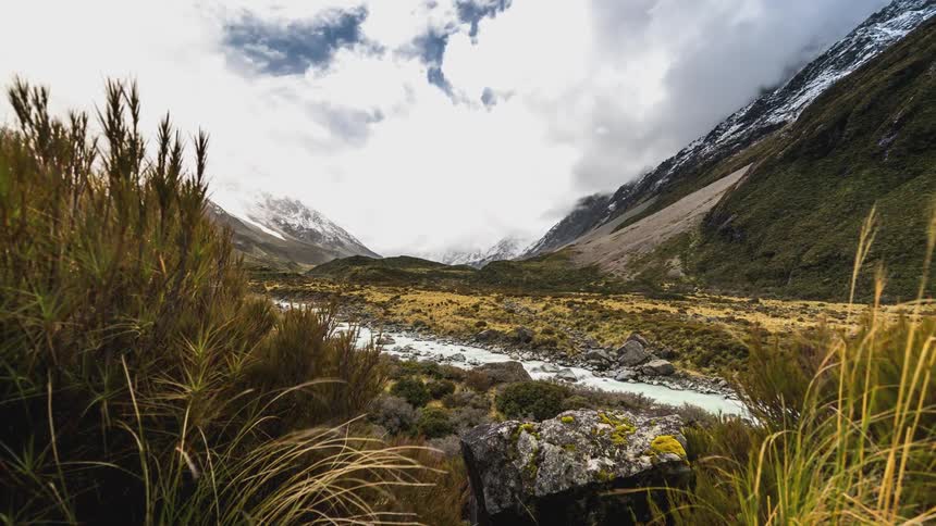 A small stream meanders through a mountain valley