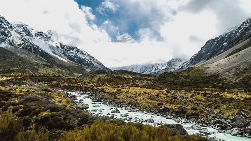 A stream flows through a rocky mountain valley