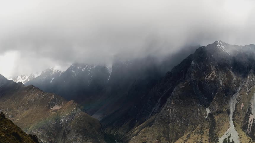 Snowy mountain range on a cloudy day