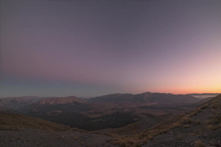 Shadow covers the landscape as the sun sets