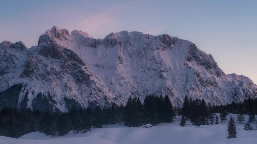 Airplanes fly over a snow covered mountain