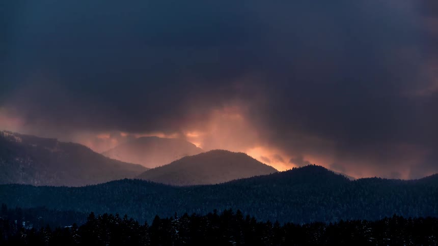 Silhouette of mountains with forests and the darkening day