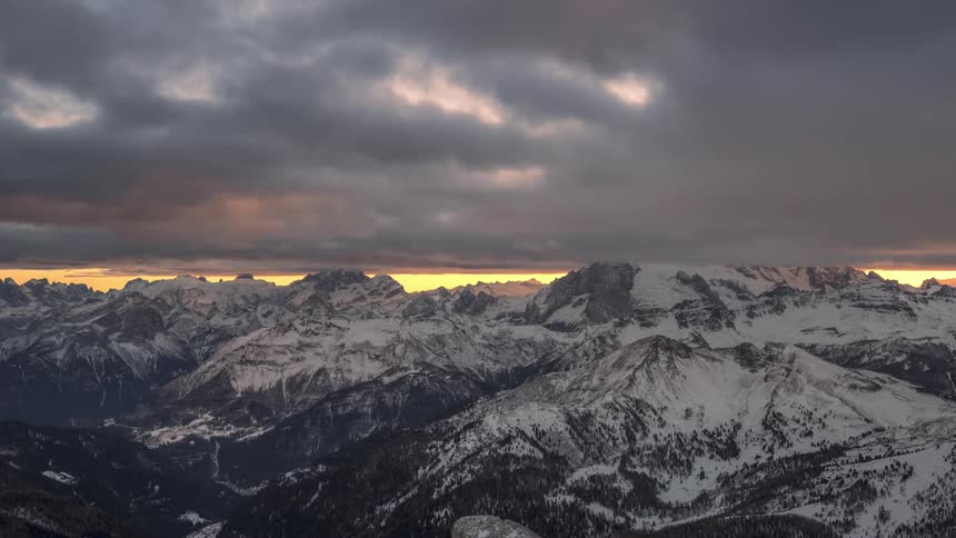Dark clouds over a massive mountain range