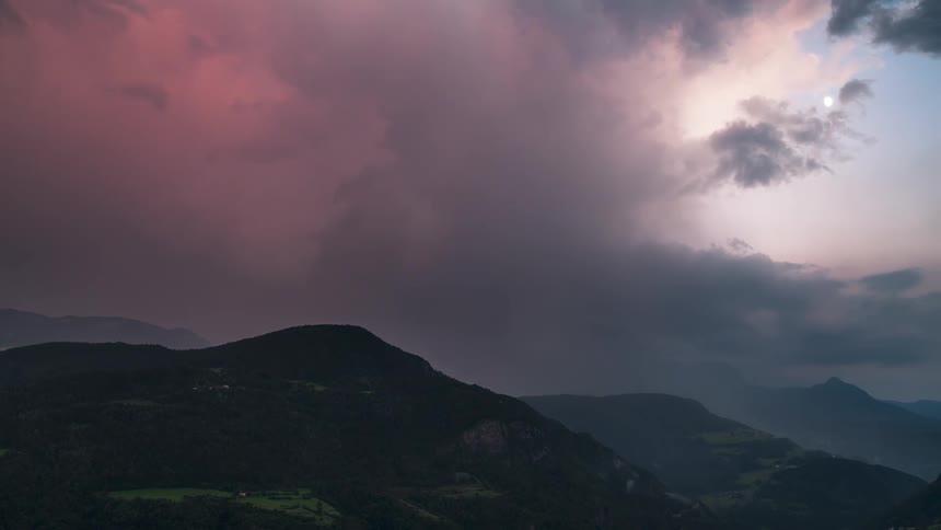 Greenish mountain range with nebulous clouds and reddish sky