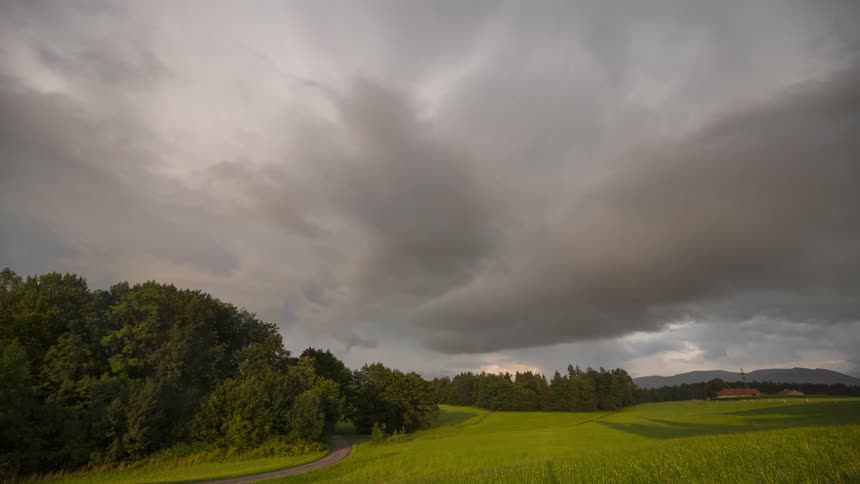 Storm clouds are pouring rain in the distance