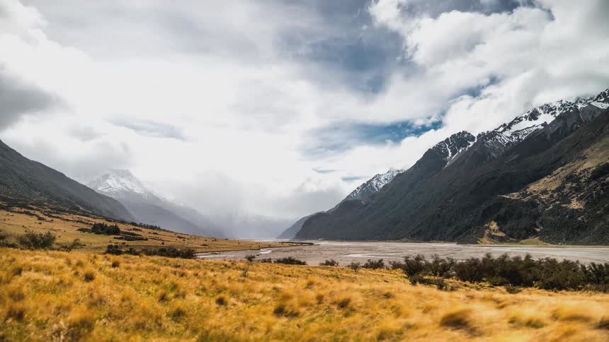 Fog and clouds flow over the mountains ahead
