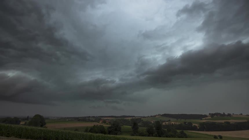 Heavy storm clouds spin over the landscape