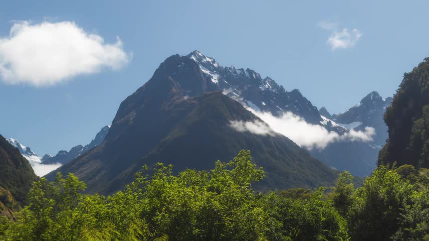 Natural landscape with majestic mountains in the background with clouds