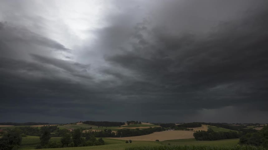 Hazy clouds above natural greenish fields