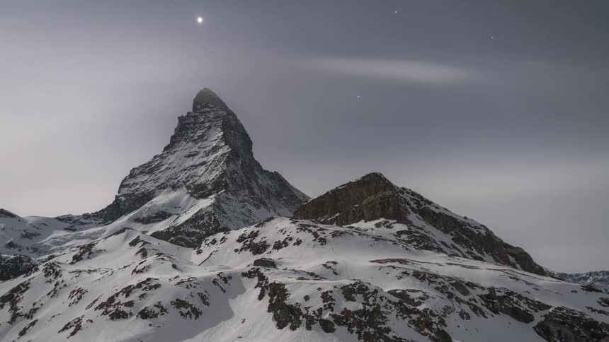 Snowy mountains with cloudy clouds