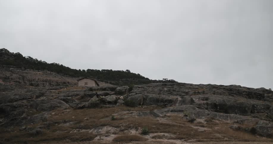 A small house is on the top of this mountain