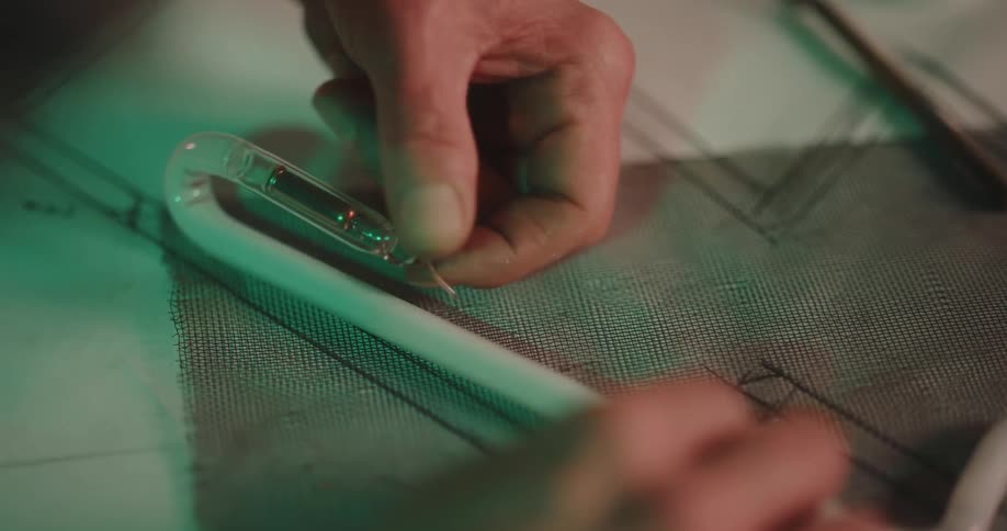 A man is designing a neon light tube