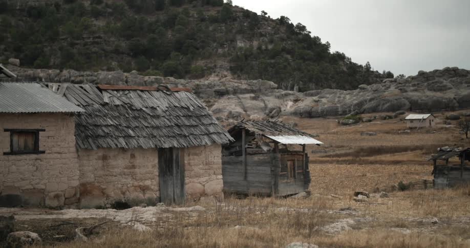 A small building with a shed sits near this mountain