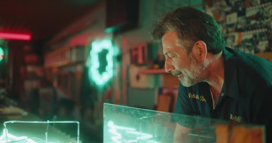 A man talking while testing neon lights
