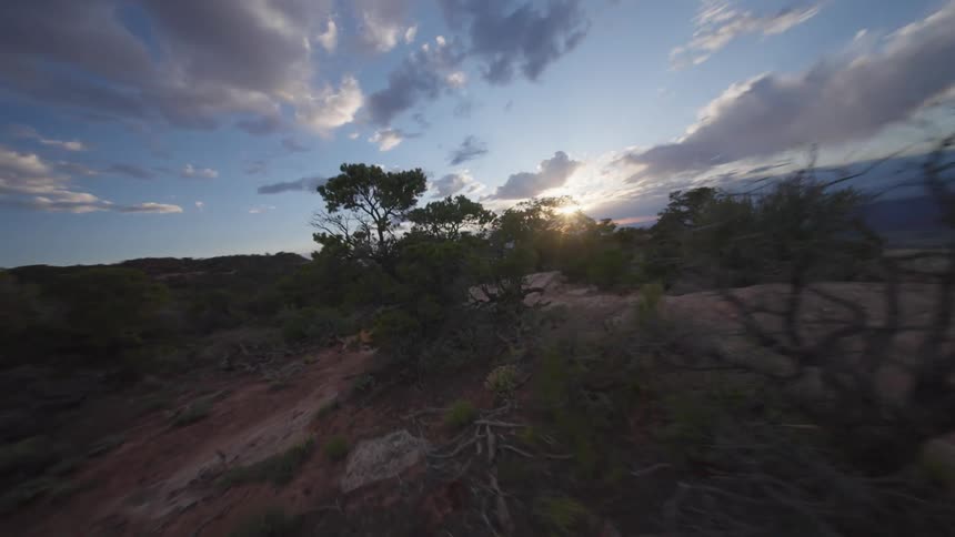 Natural landscape with a reddish earth cliff and a person running on a mountain bike