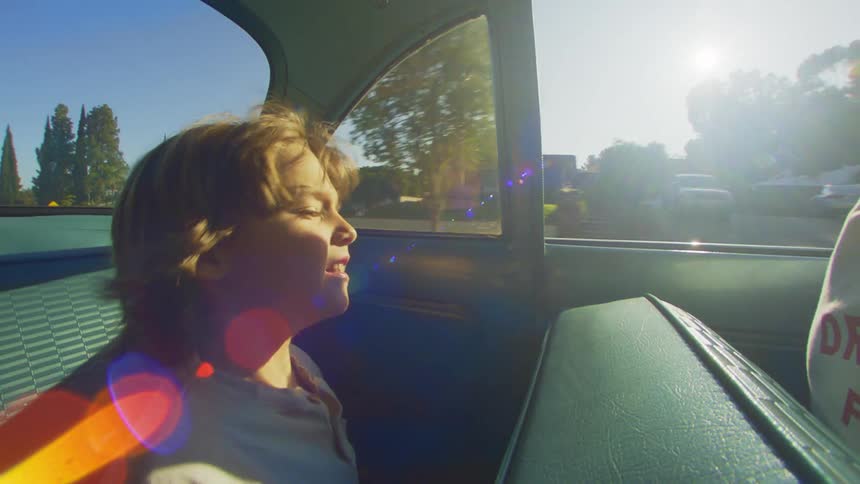 Little boy sitting inside a vehicle