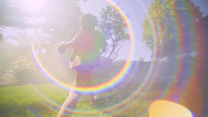A child is running through his backyard