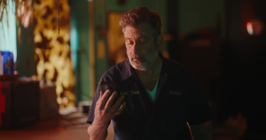 Man indoors using cell phone