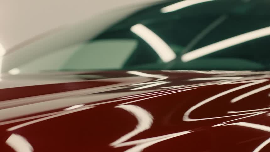 Front part of the hood of a red varnished vehicle