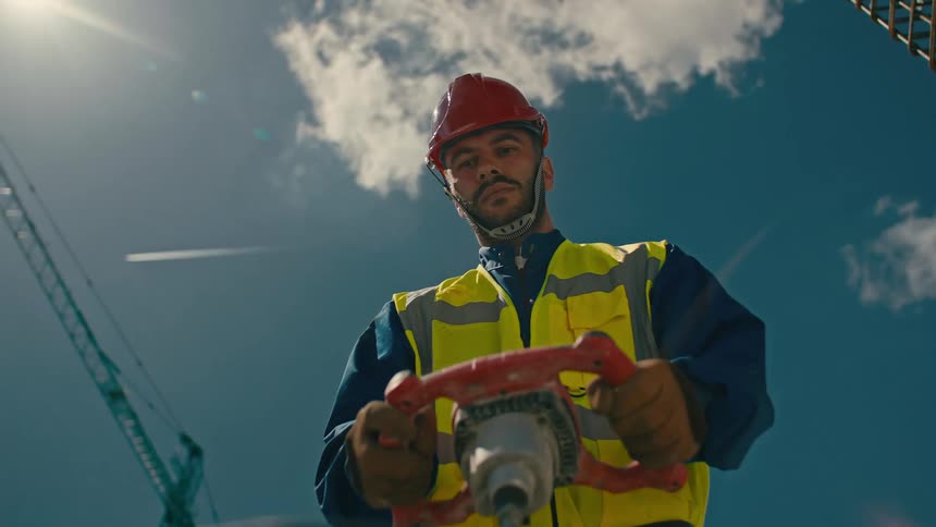 A construction worker mixes cement