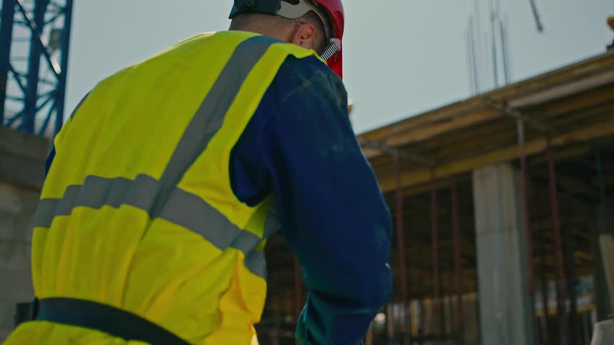 Closeup of construction workers hands working with steel reinforcement bars