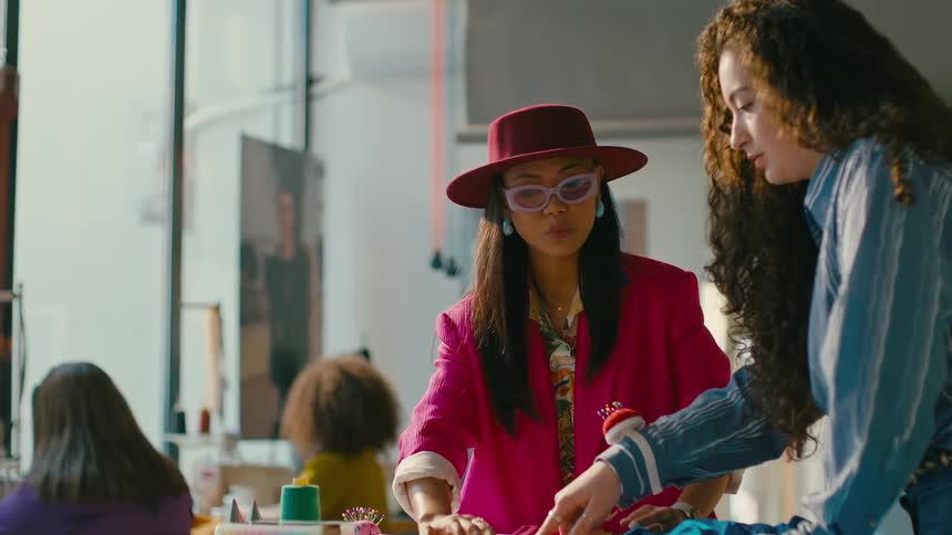 Two fashion designers creating clothes on a workshop