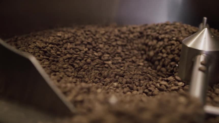 Coffee beans are being mixed in a large machine