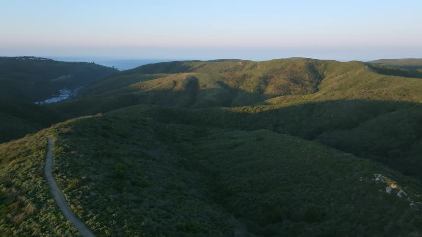 Aerial scenery of greenish hills and mountains in a morning sky
