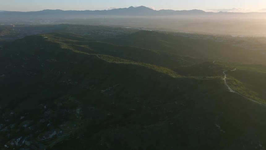 A small city and suburb separated by a mountain