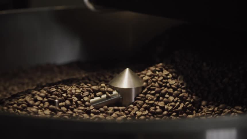 Coffee beans being roasted in a machine