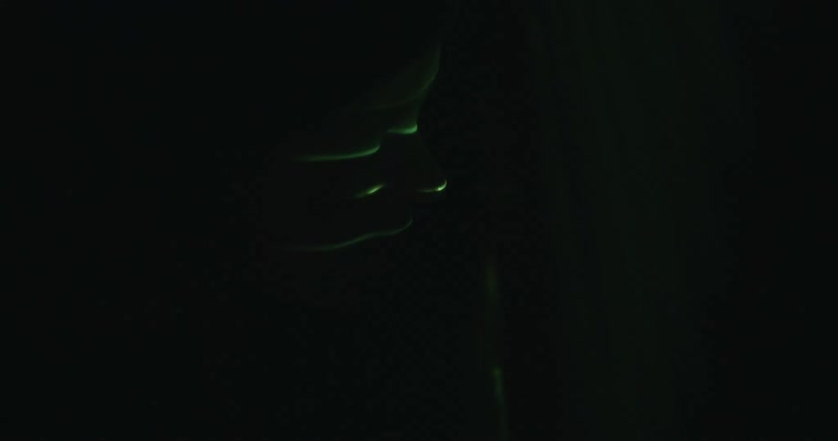 Green lights flashing in a dark room