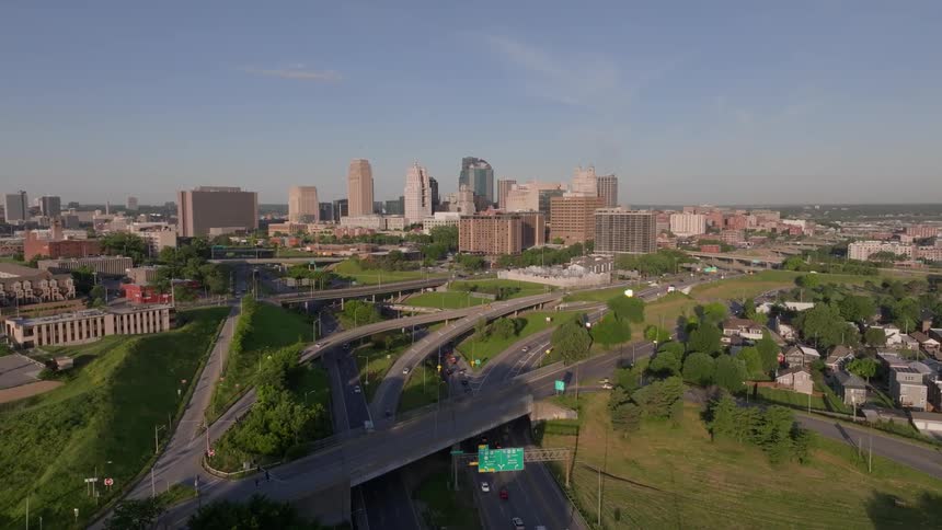 Aerial view of an urban area during the day with tall buildings and intertwining roads