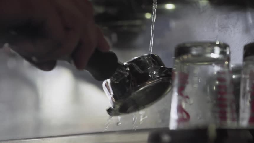 Barista rinses espresso tool