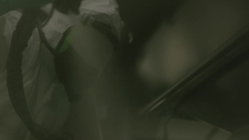 A worker is spray painting in the factory