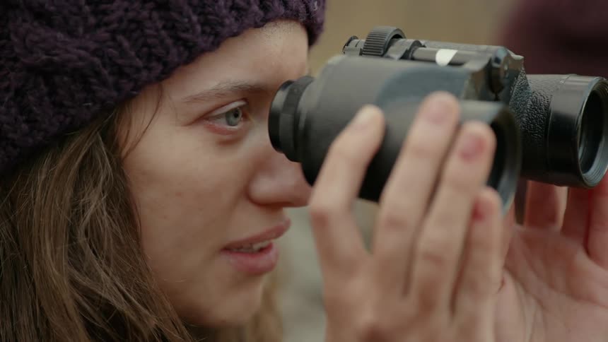 Woman looking into binoculars