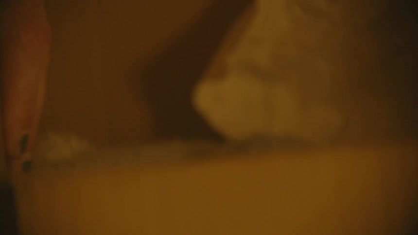 Person holds flap of a cardboard box down against its side