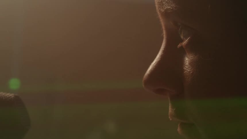 Side portrait of a woman with a fearful facial expression and a green laser passing over her face