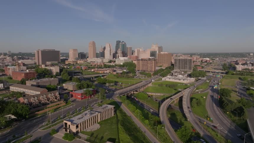 Traffic outside a metropolis under a blue sky