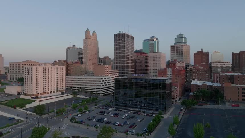 A large city downtown surrounded by roads intersections and parking lots