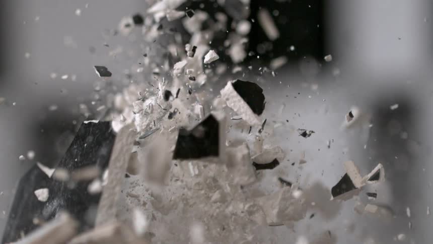 A hammer smashes through an object and shatters it