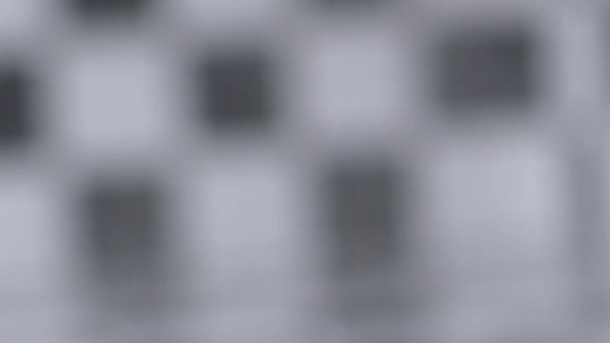 The blurry view of a hammer shattering a surface and scattering shards of material
