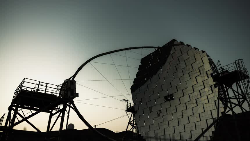 A space antenna switches positions as night turns to dawn