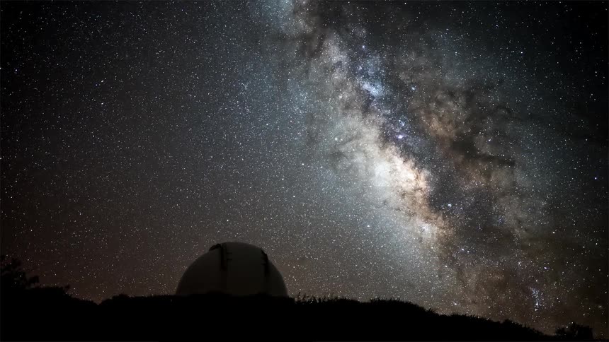 Night view of the starry sky with the milky way and an observatory