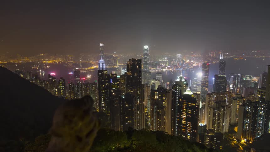 A sprawling city filling a valley with lots of flashing lights at nighttime