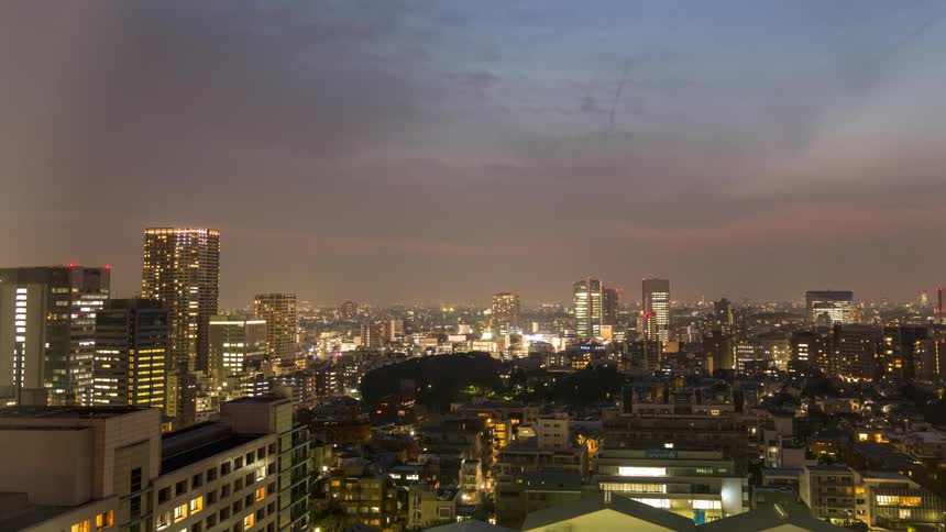 Day changes to night as a city lights up