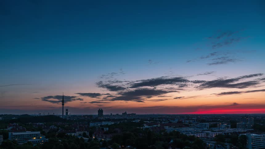 The sky is red as the sun sets on the town