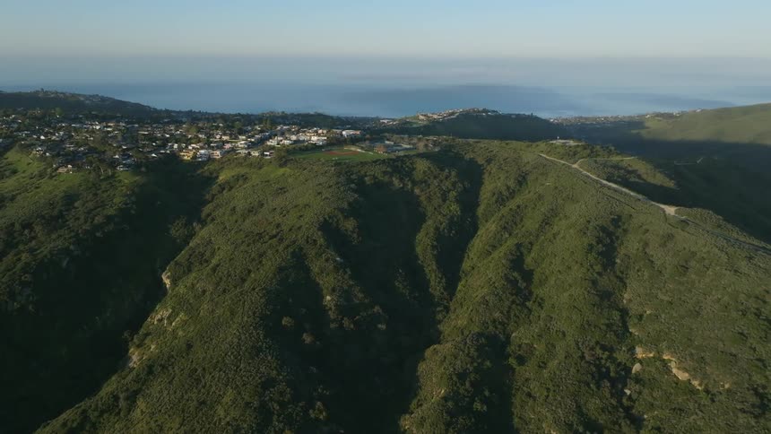 A small rural town sitting on top of a forested mountain