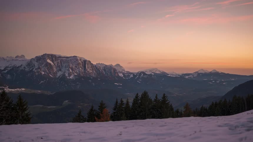 Snow covered mountains and sunset happening