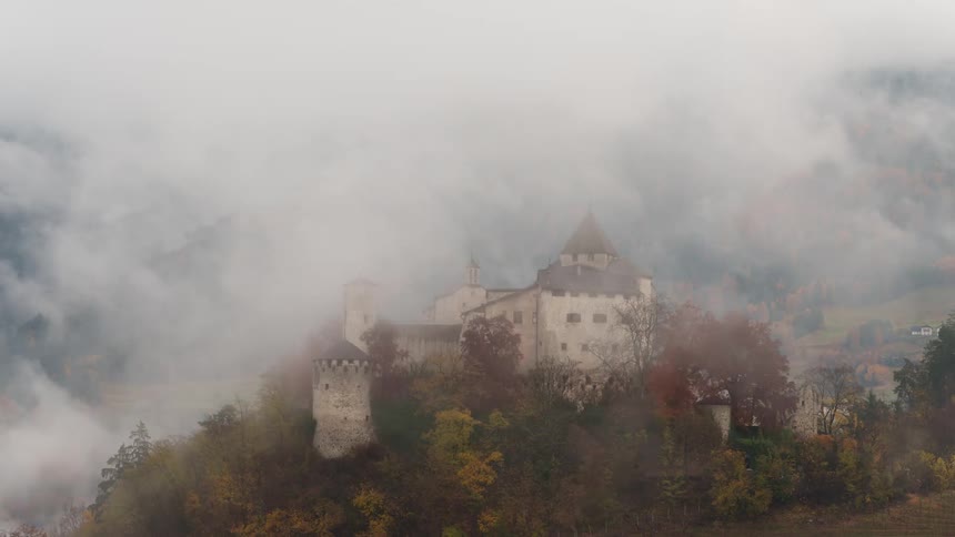 Prsels castle partially shrouded in rapidly clearing mist during the fall