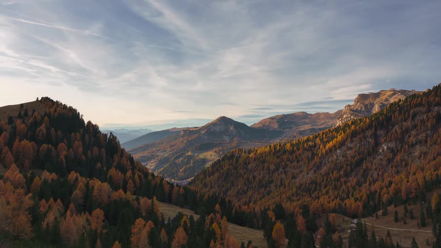 Landscape of mountain ranges with colorful conifers
